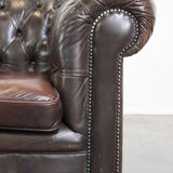 Old dark brown 3-seater cowhide chesterfield sofa with lots of character