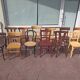Set of 12 mismatched wooden bistro chairs