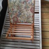 Wooden footrest and vintage tapestry
