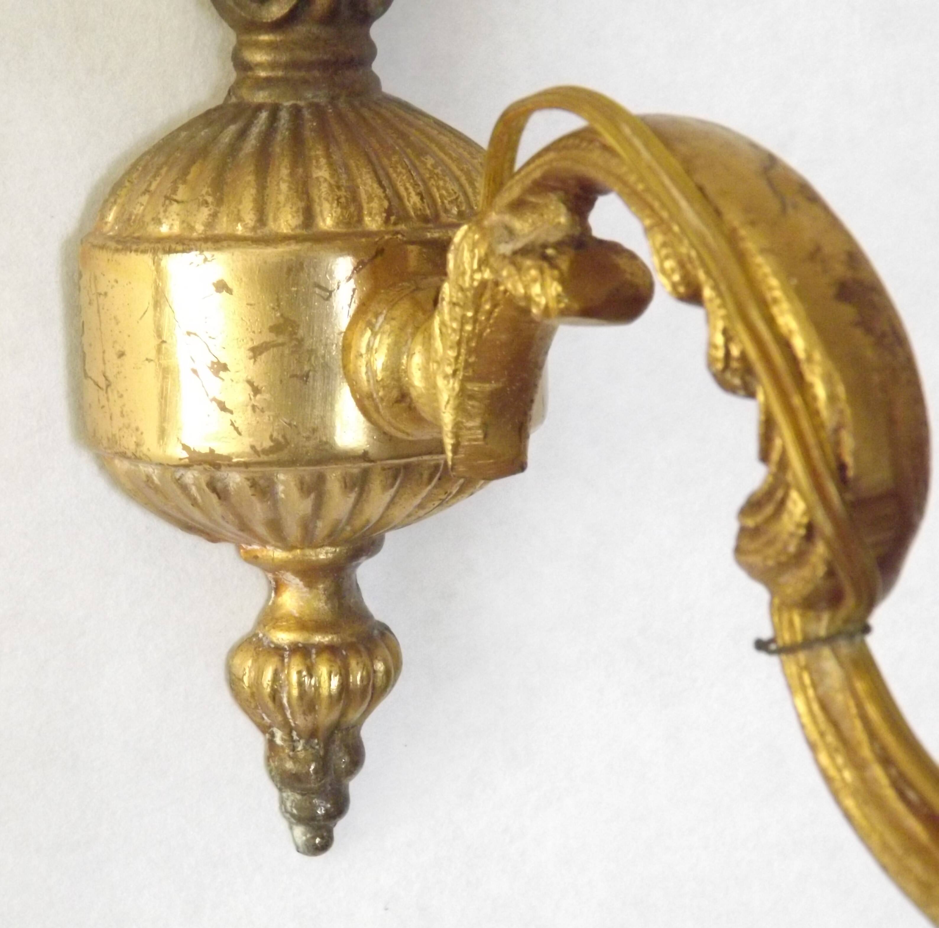 Pair of simple vintage French wall sconces in Art Nouveau bronze with leaf-shaped details.