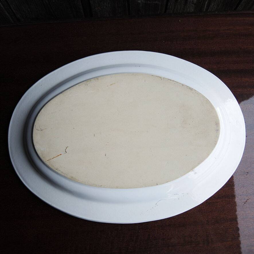Old large oval serving dish in Moustiers earthenware.