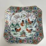 Porcelain plate with several roosters