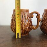 Set of 2 vintage caramel-colored slip mugs with flower pattern