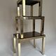 Set of three nesting side tables in brass and smoked mirror.
