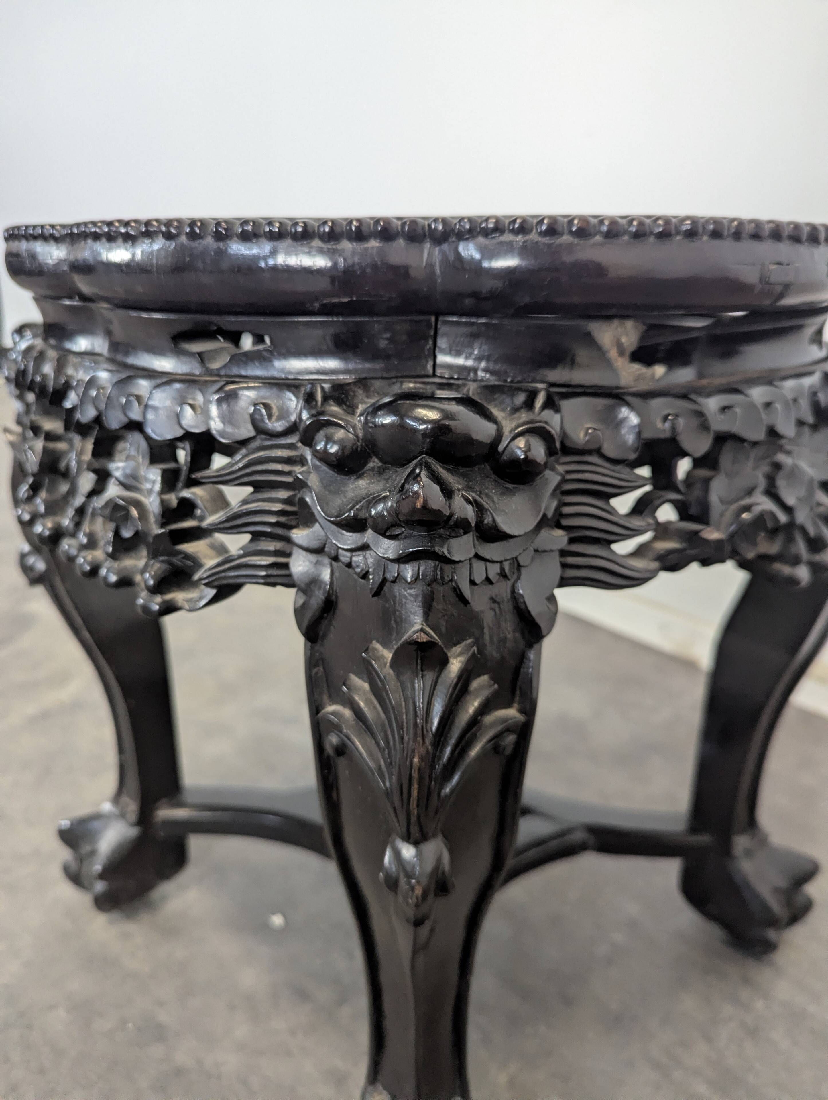 Side table with a wooden frame and marble top.
