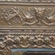 Bevelled mirror from the 1930s in repoussé brass.