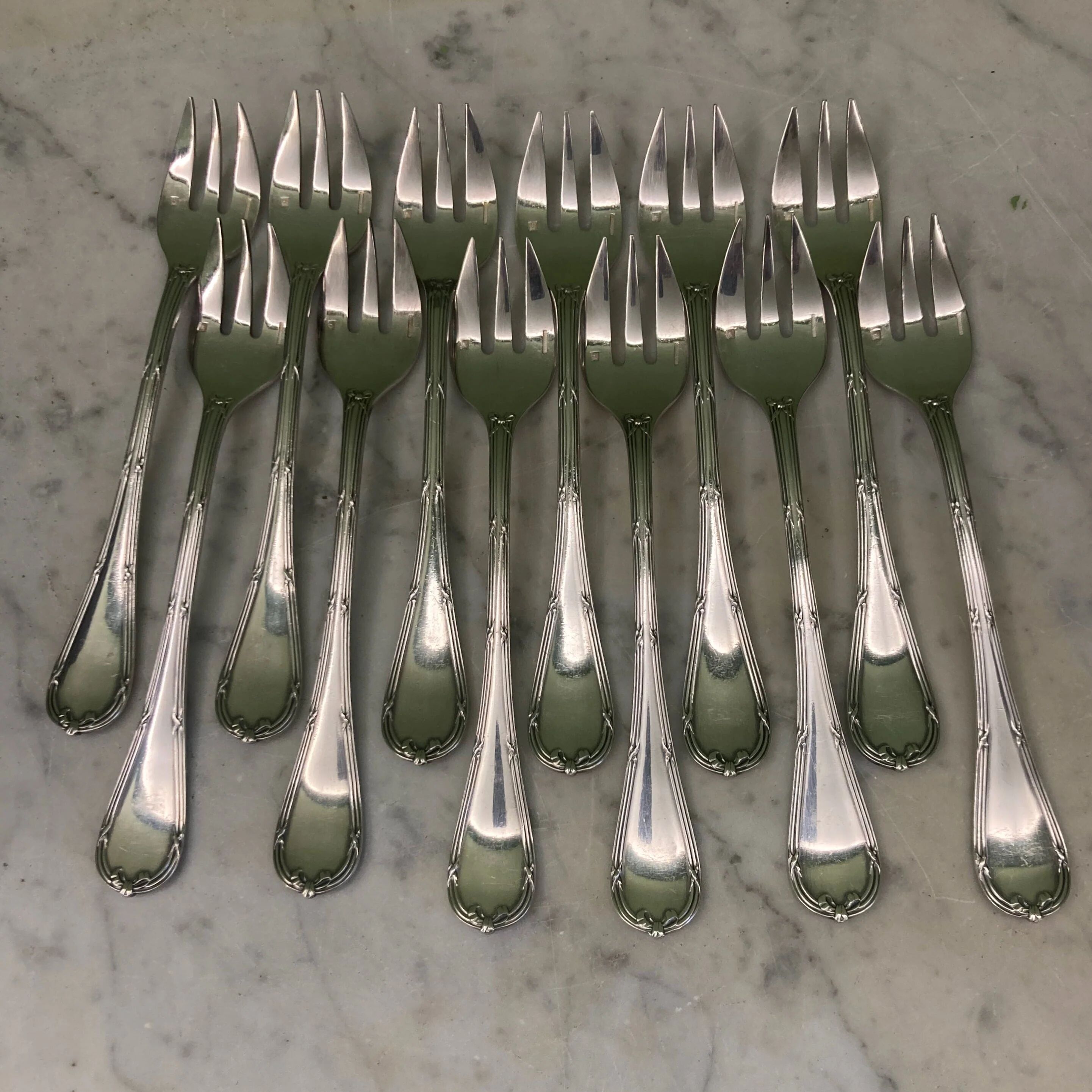 Christofle house 12 crossed ribbon oyster forks