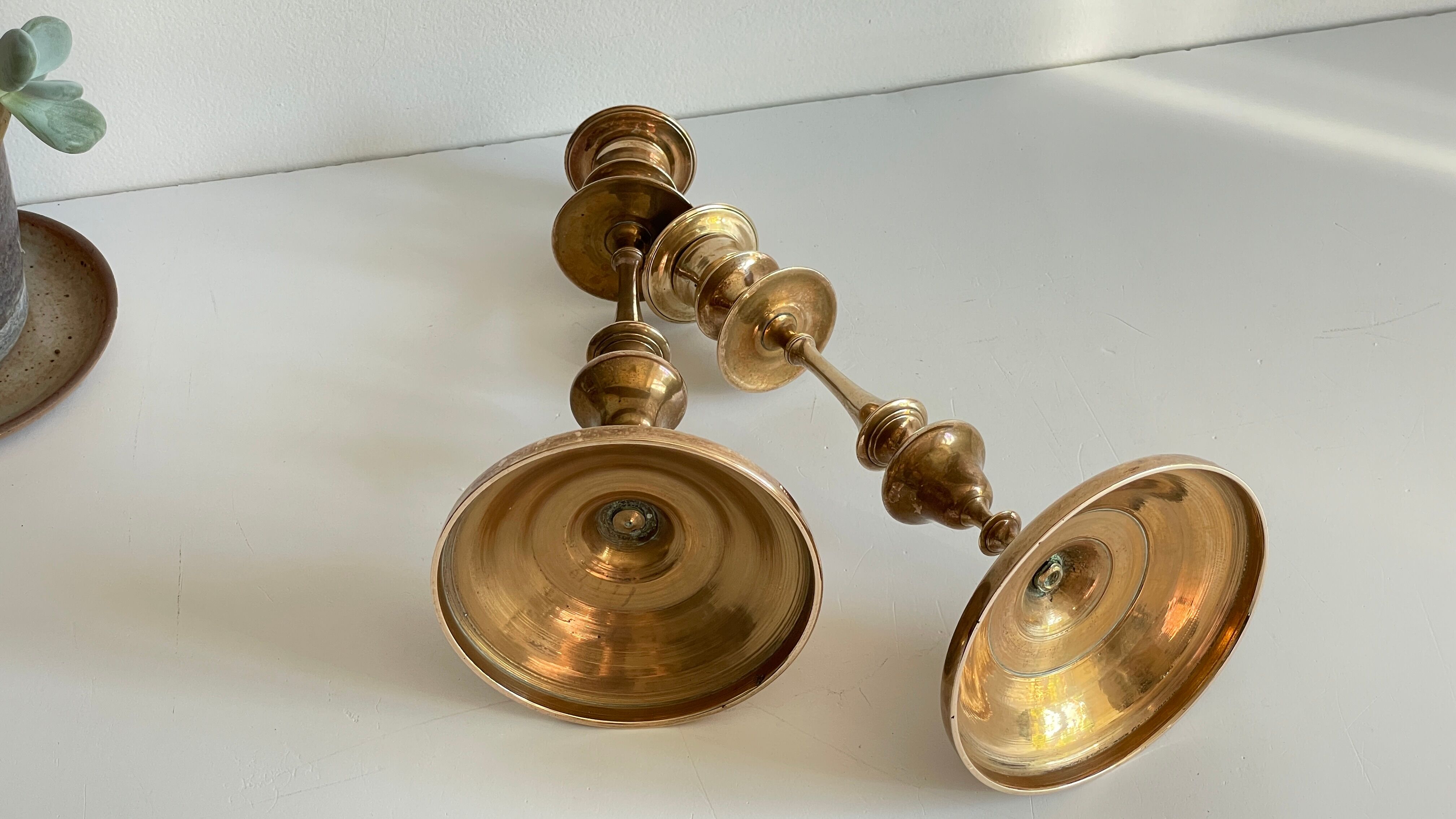 Pair of antique candle holders in solid brass