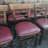 Set of 4 bistro chairs in curved wood and vintage red skai seats.