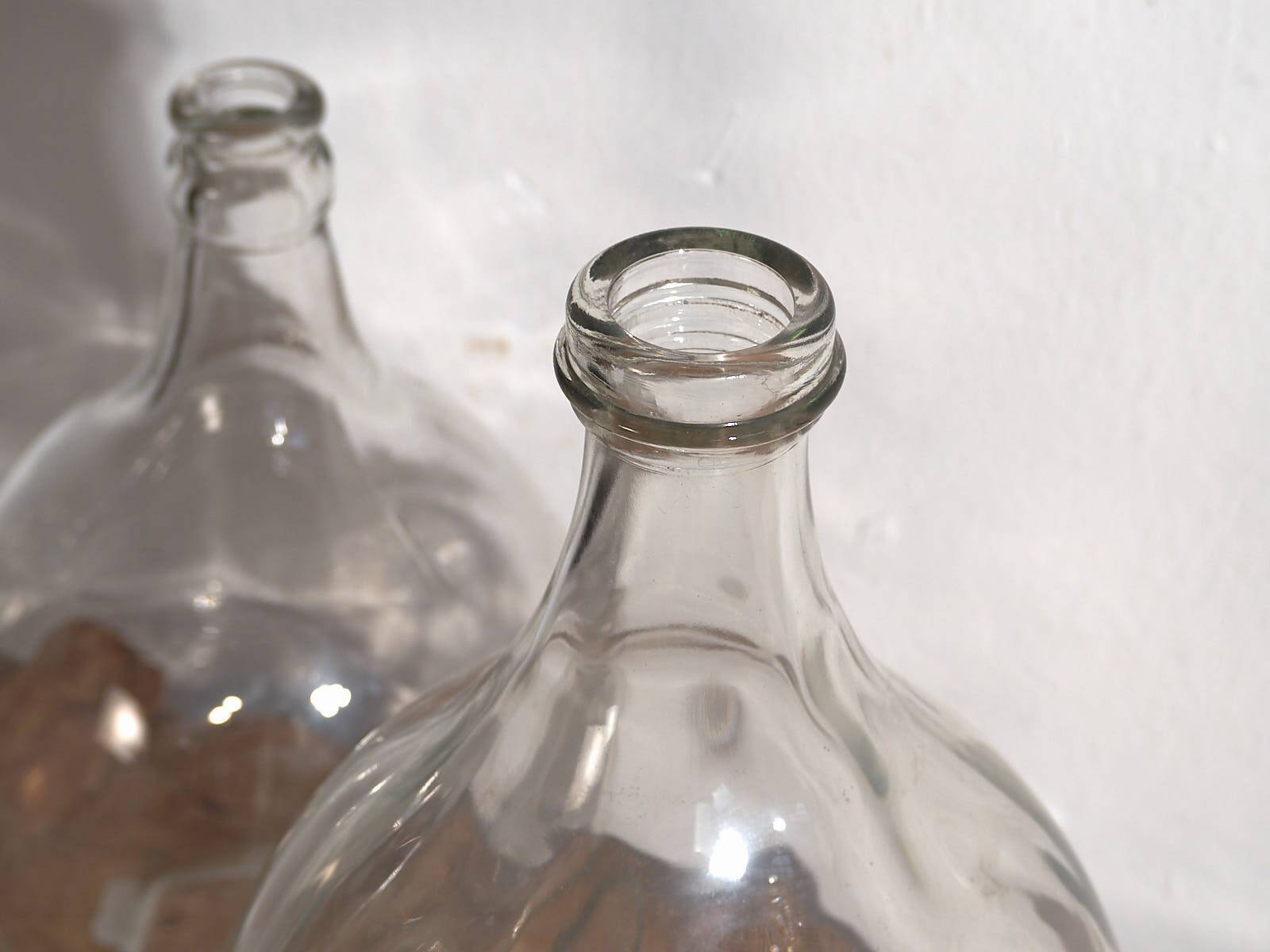 Antique glass demijohns (c.1920). Set of 2 pieces