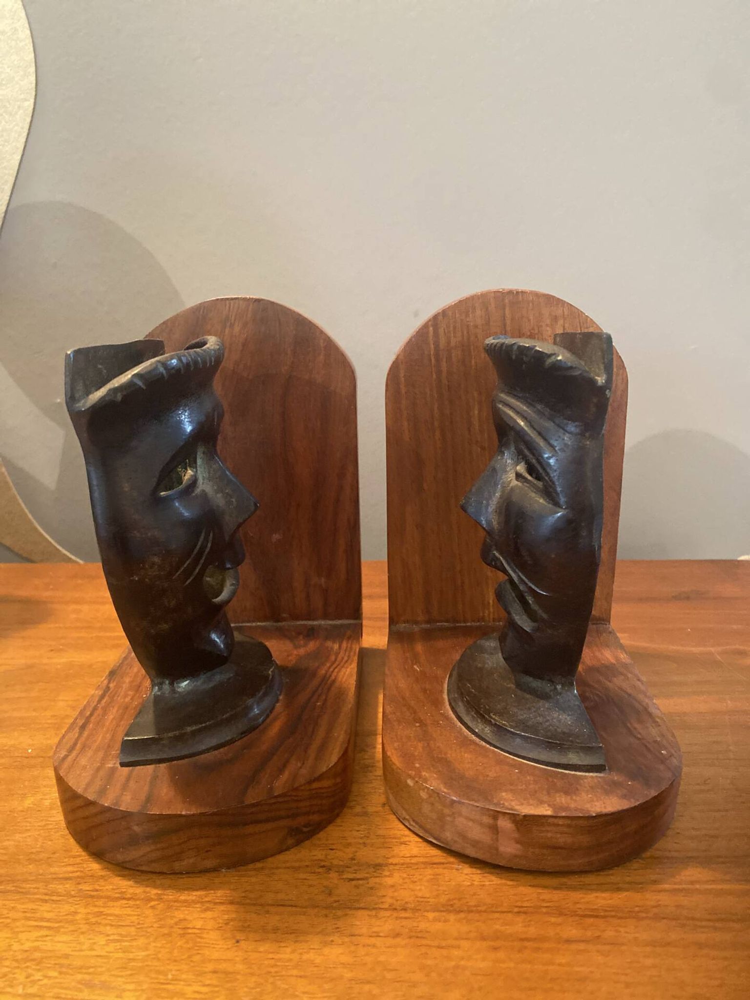 Pair of bronze bookends with masks