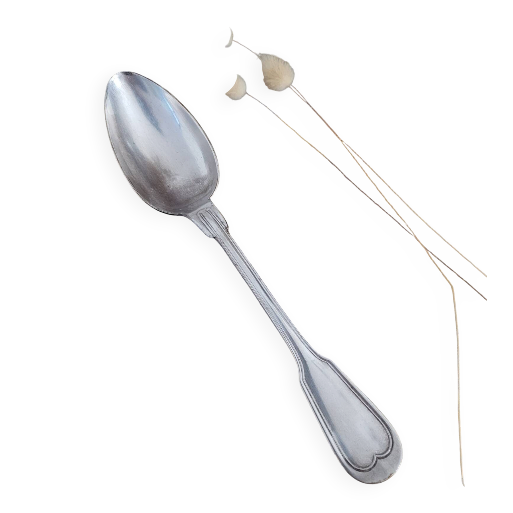 Large silver spoon with net decoration.