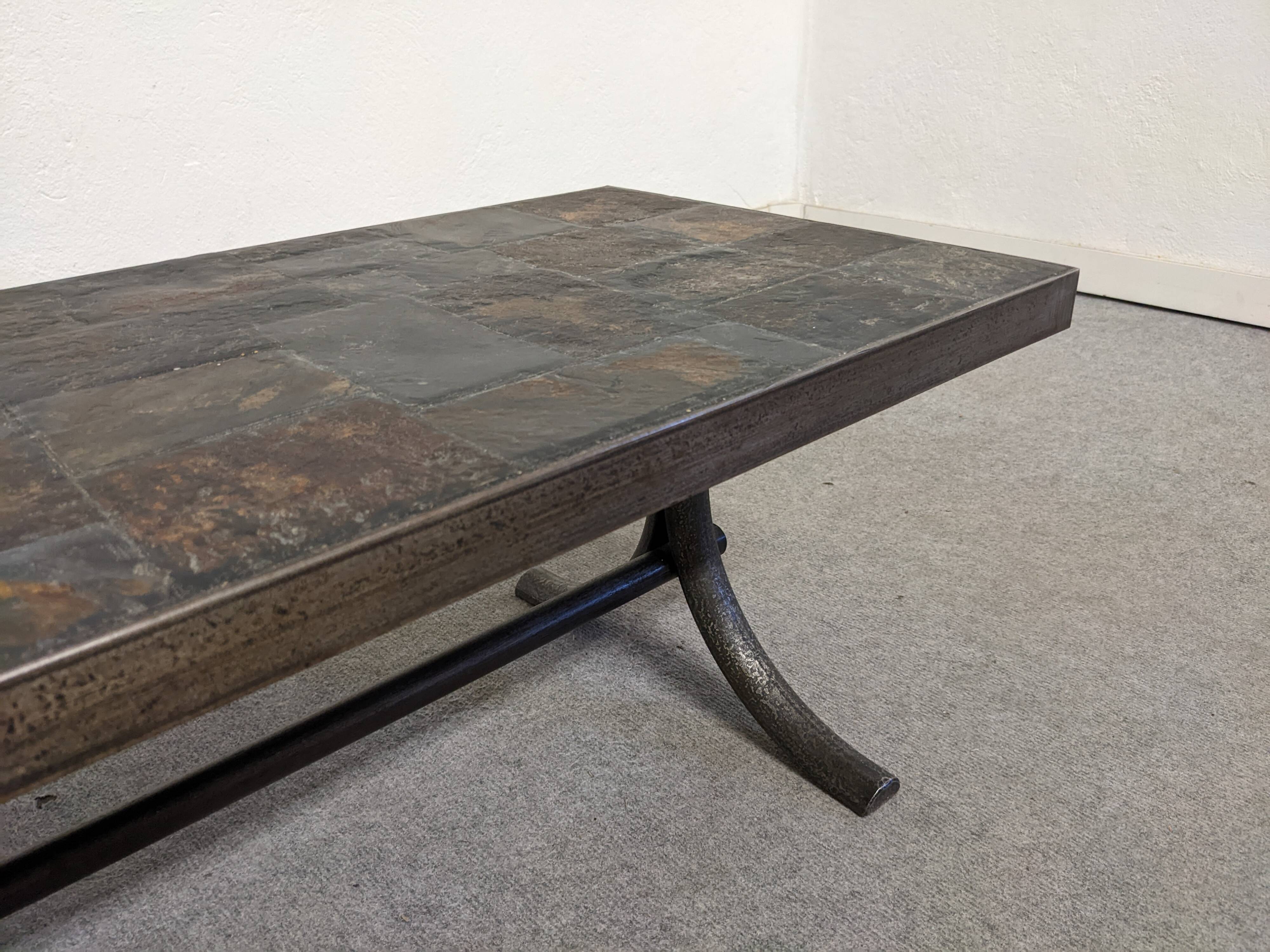 Brutalist coffee table in natural stone and wrought iron, France circa 1960.