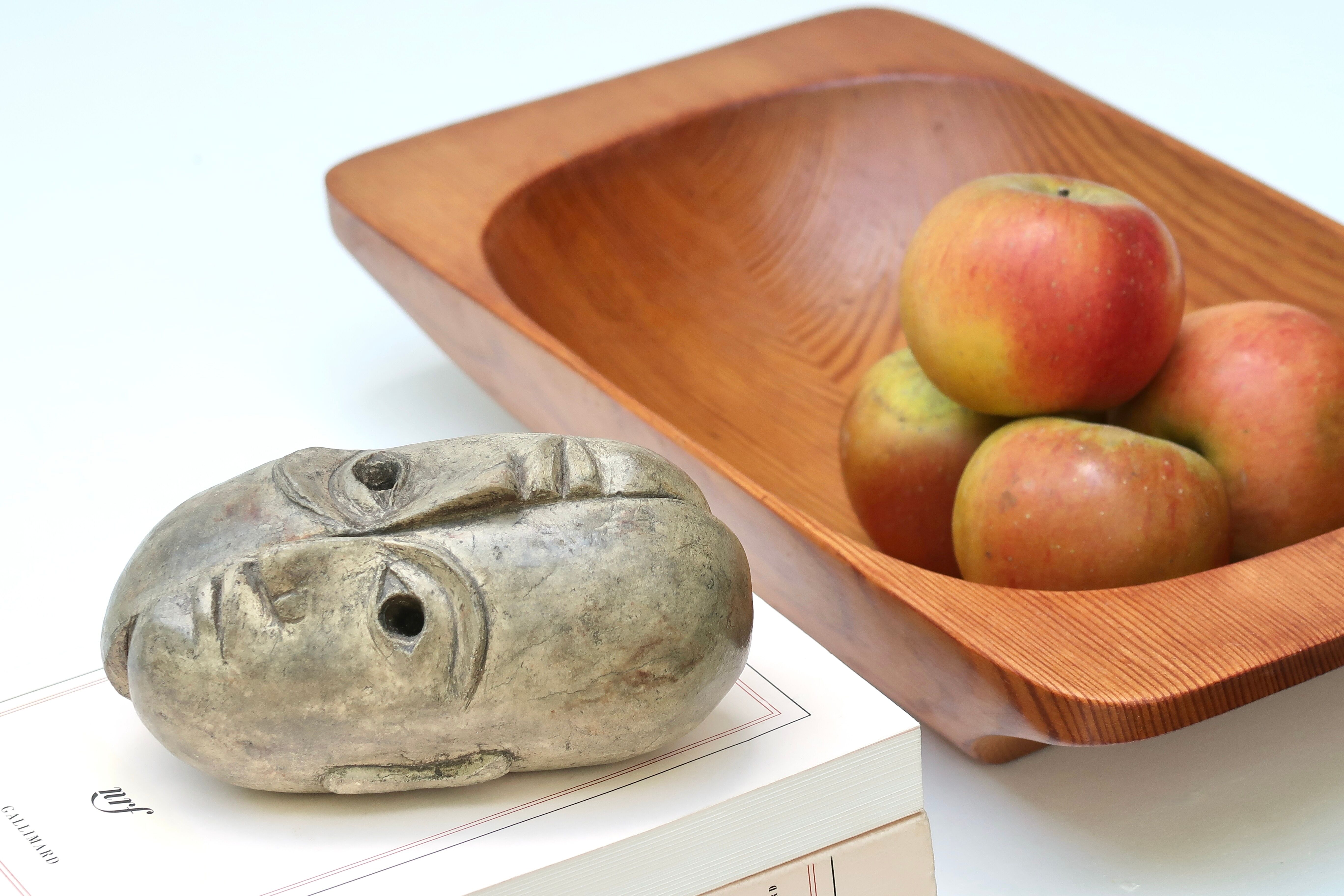 Patinated plaster sculpture paper press: Inverted faces