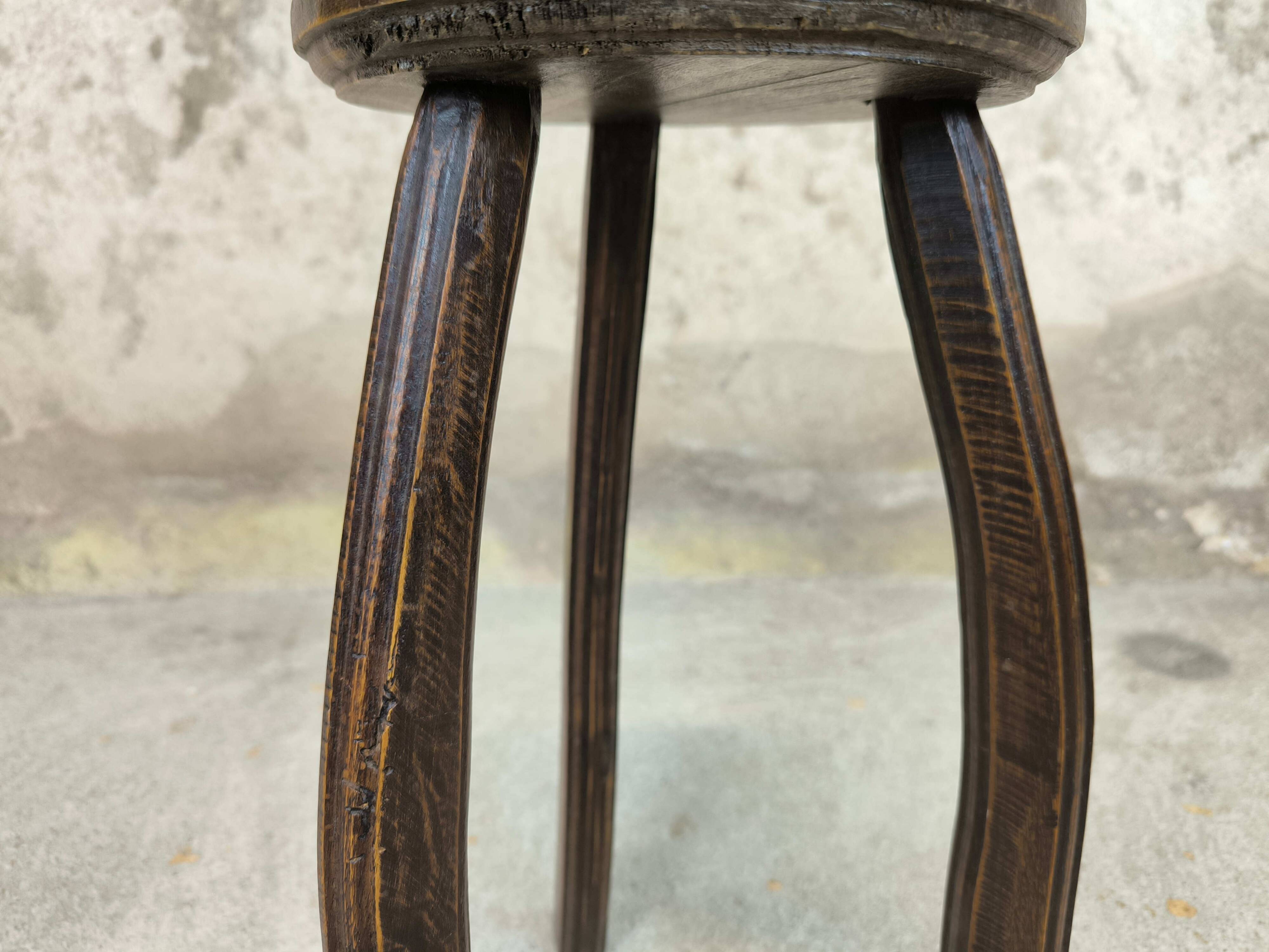 Vintage tripod plant stand with curved legs.