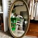 Oval mirror in wood and green and gold stucco, 75 x 42 cm