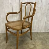 Curved wood and cane armchair