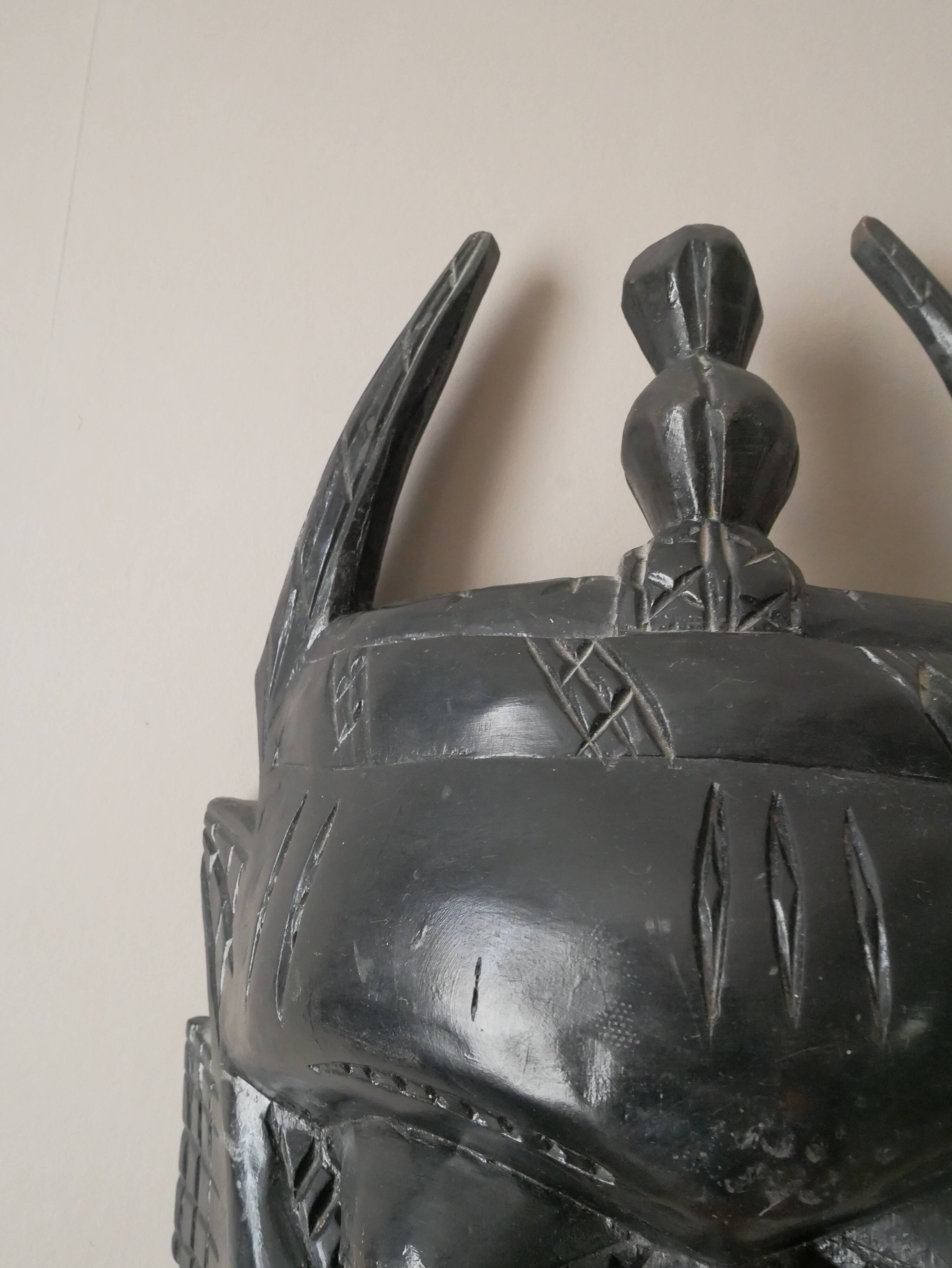 Decorative mask hand carved in tribal ethnic painted wood