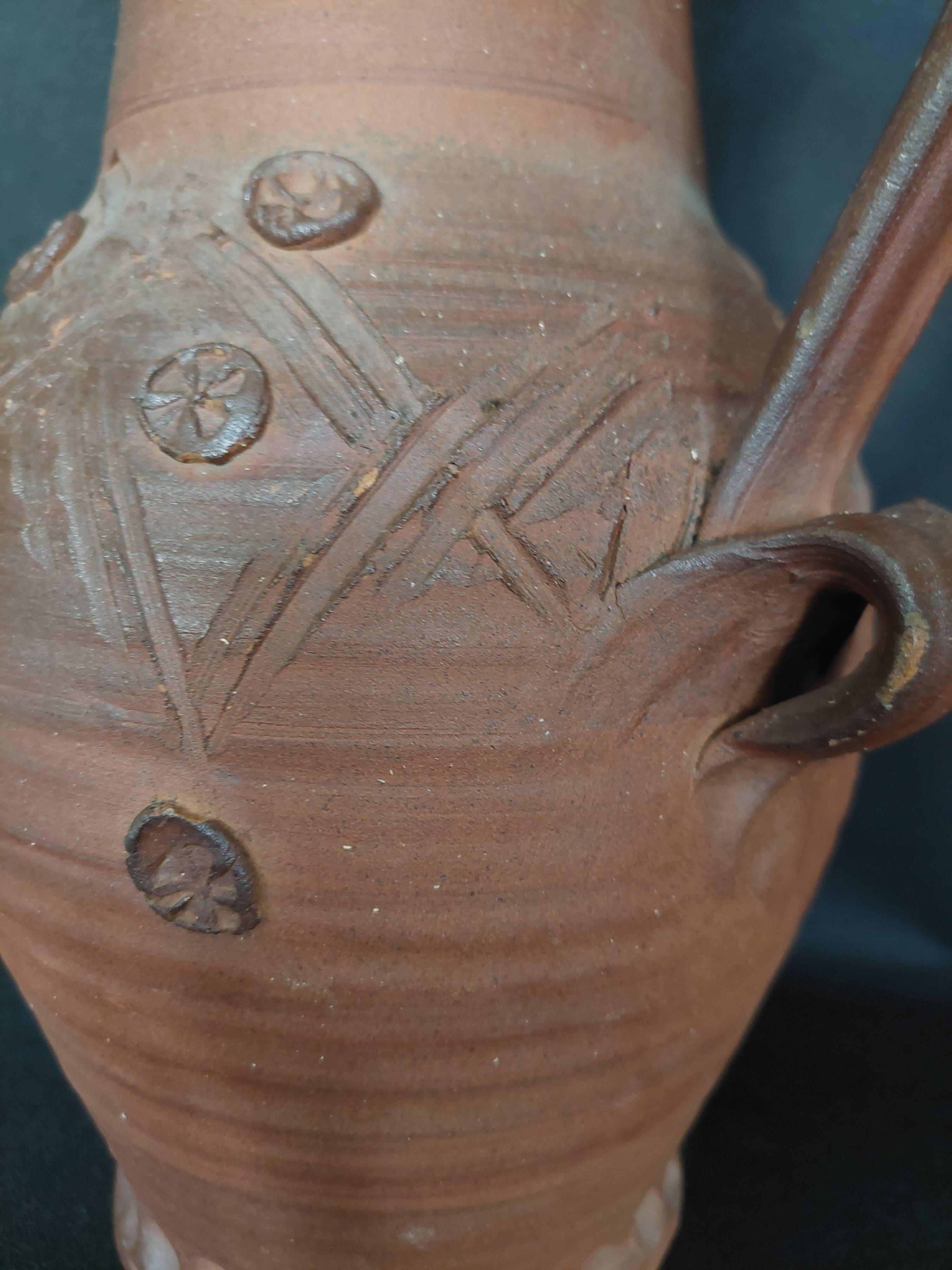 Vintage pitcher with a signature to identify.