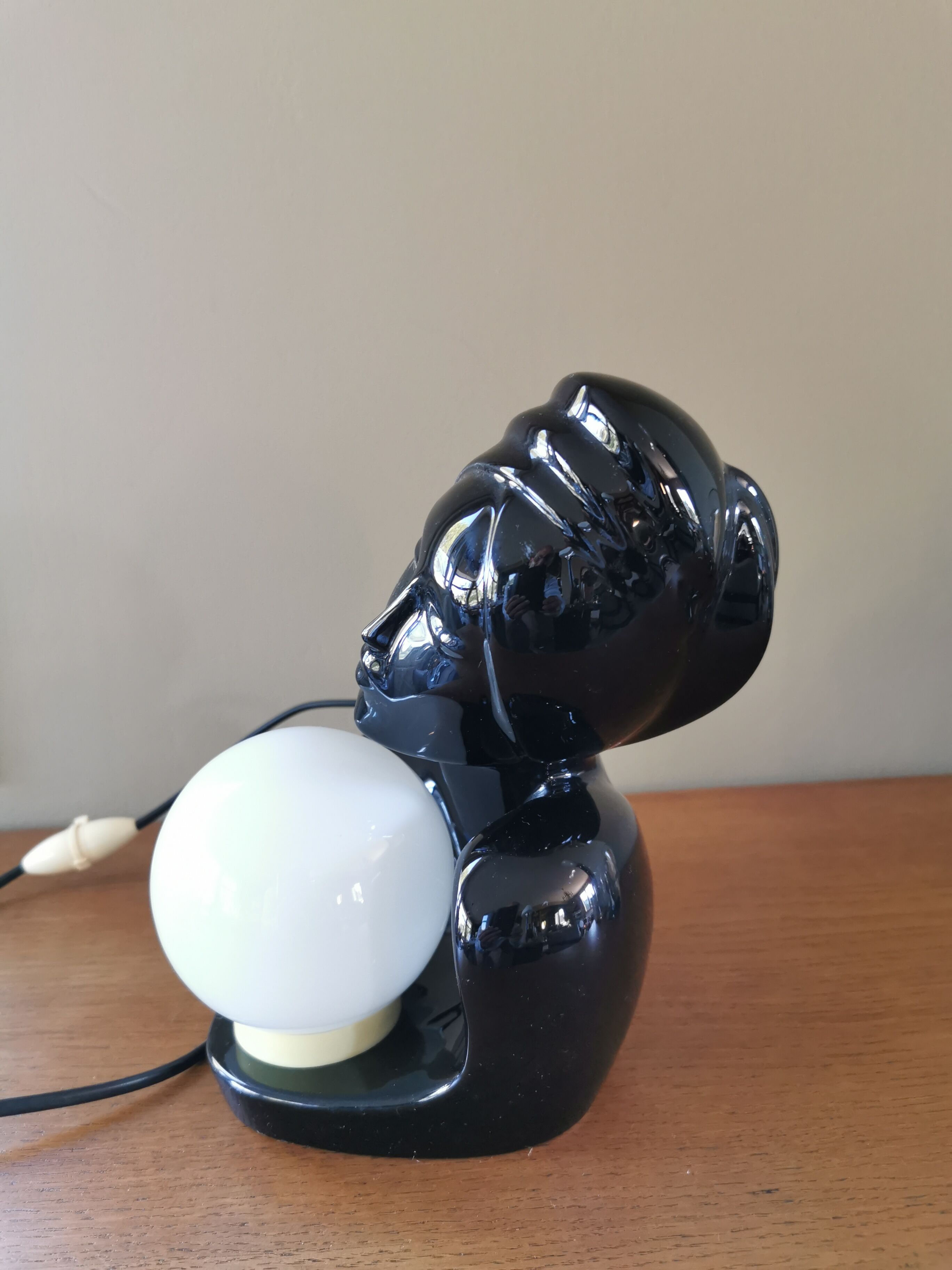 Vintage 80s lamp in the shape of a woman's bust made of black ceramic.
