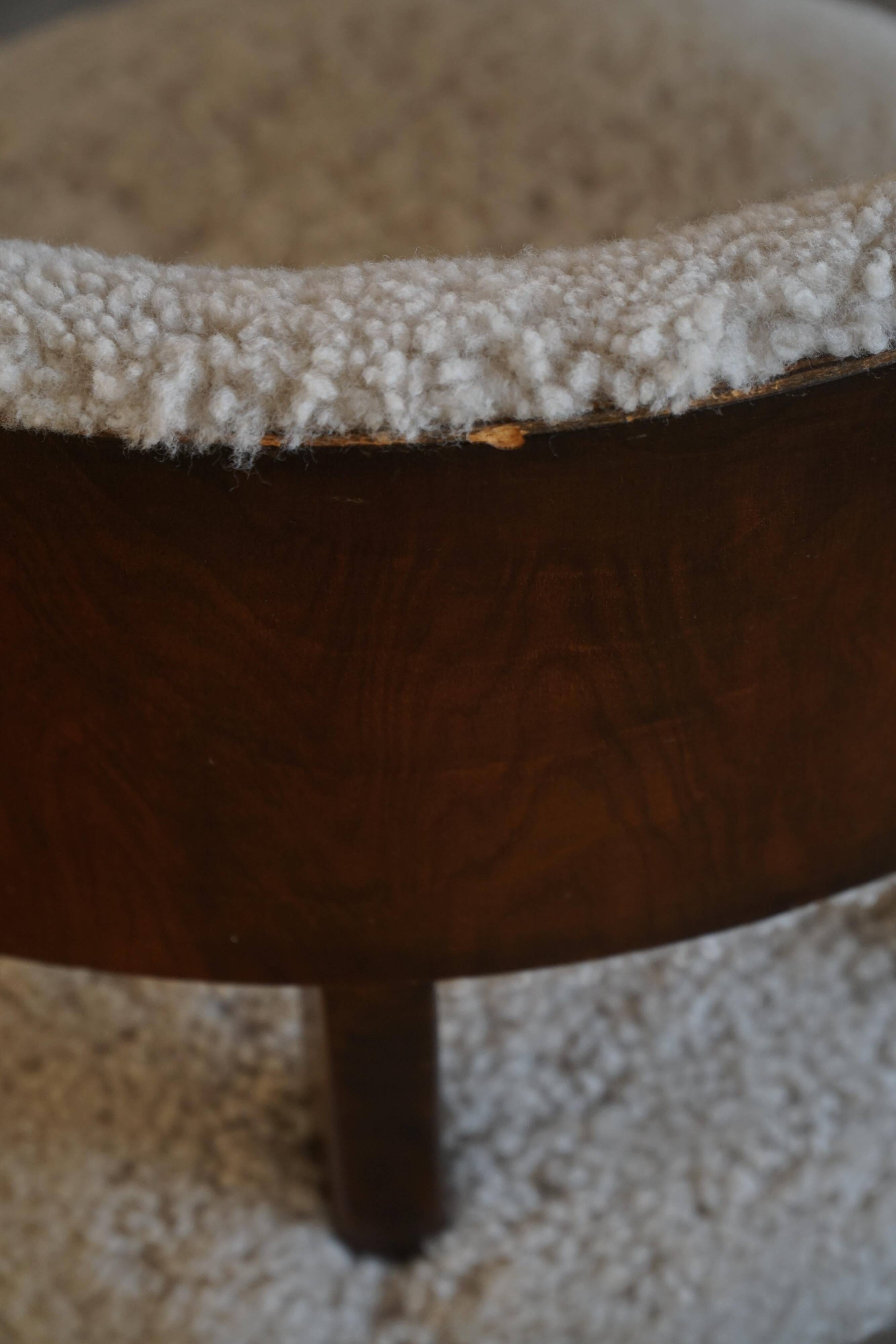 A modern Danish elegant low-back chair, reupholstered in lambswool, 1940s.