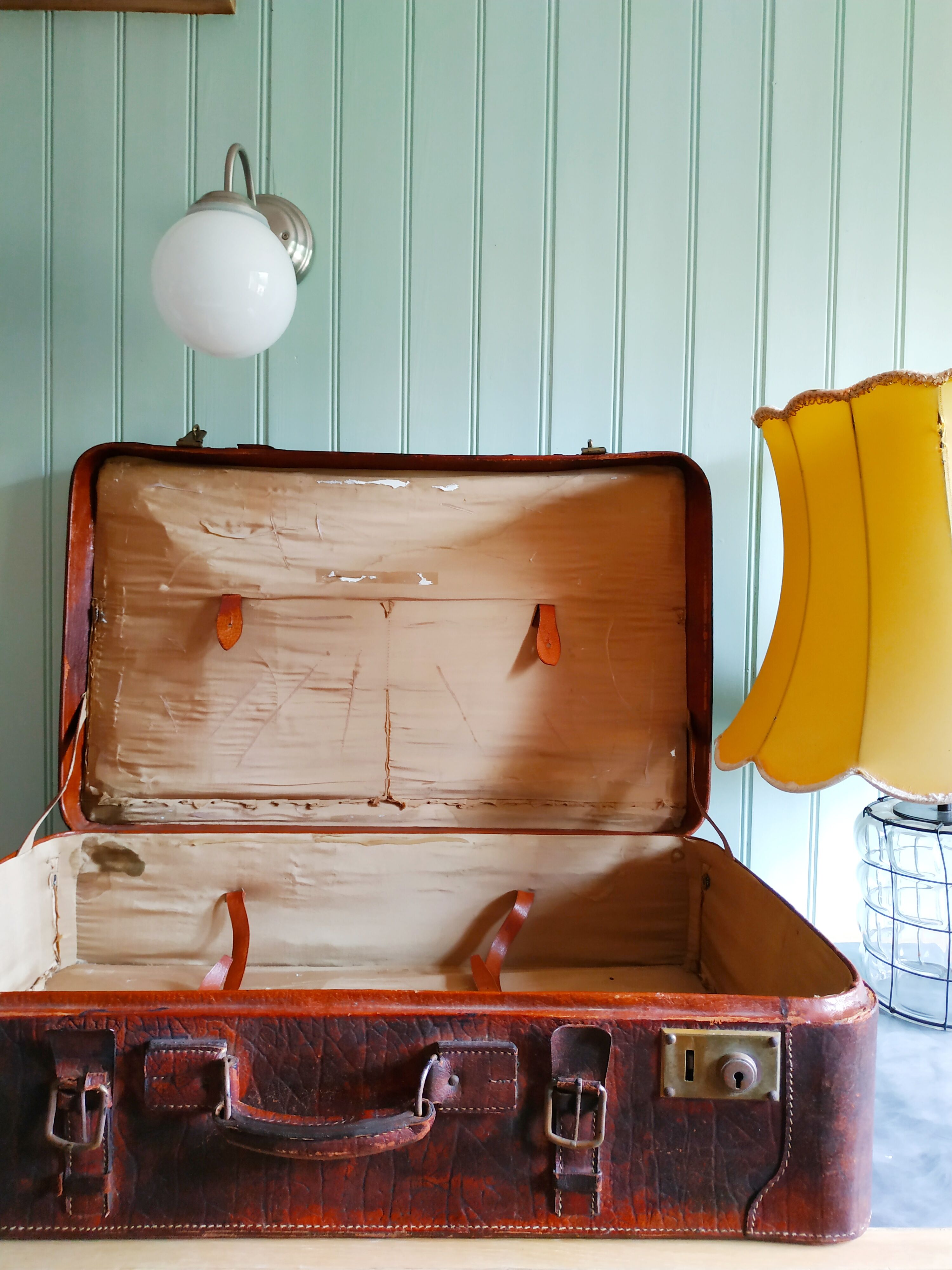 Old cardboard suitcase covered with patinated leather