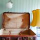 Old cardboard suitcase covered with patinated leather