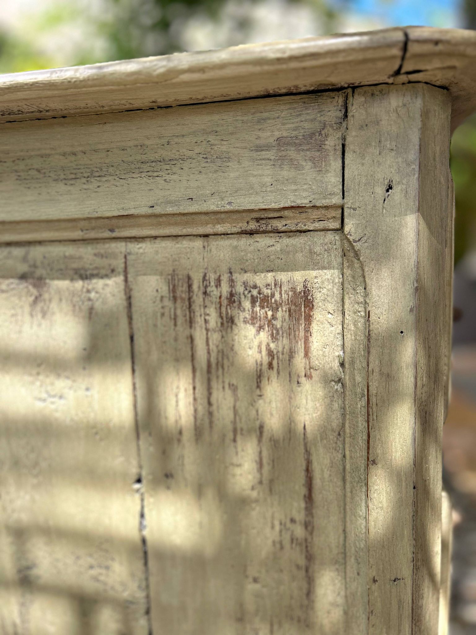 Curved antique commode in pistachio green patina.