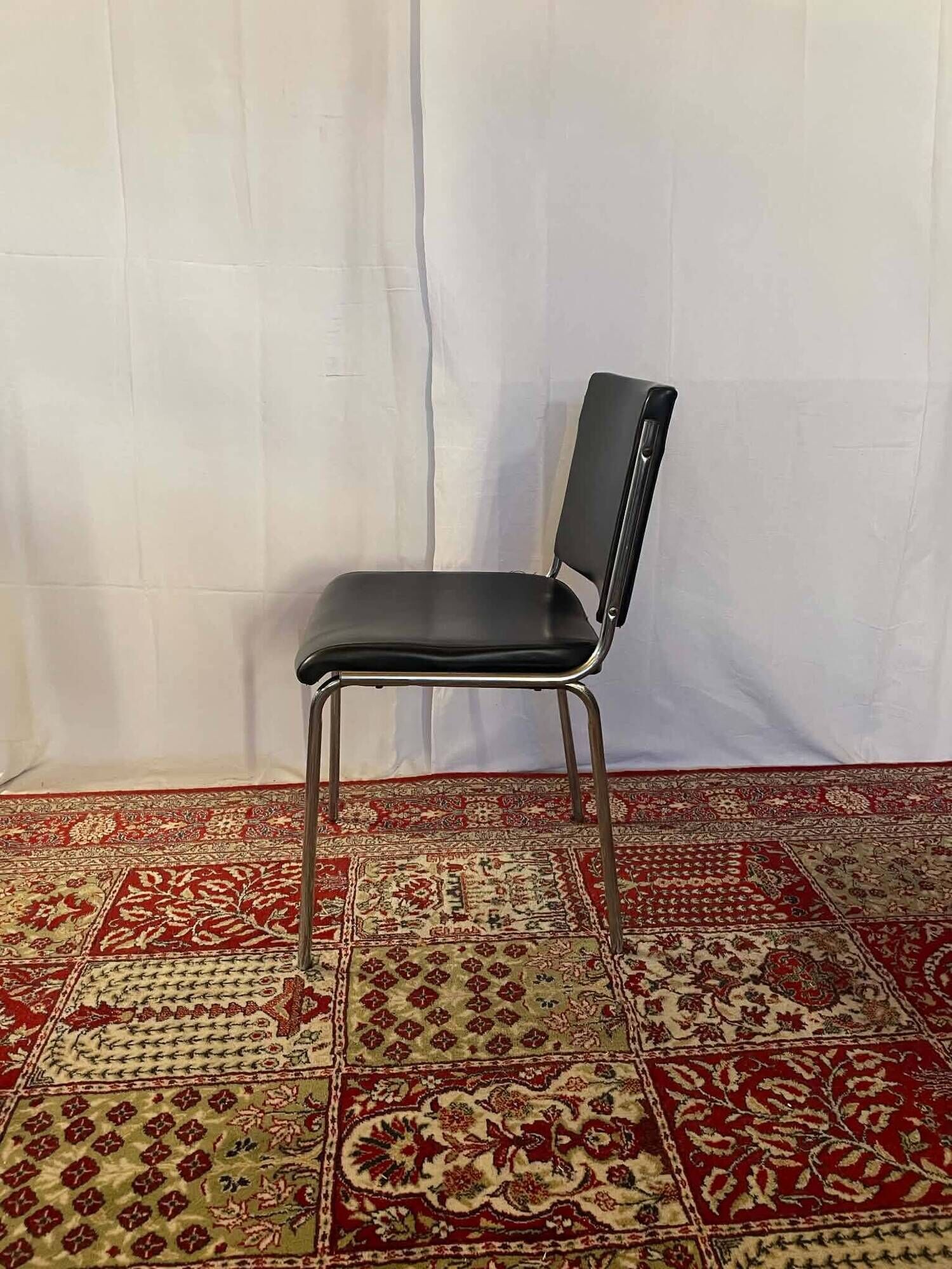 Vintage chair in black faux leather and chrome metal