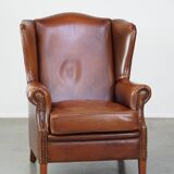 Fauteuil à oreilles en cuir de vachette cognac