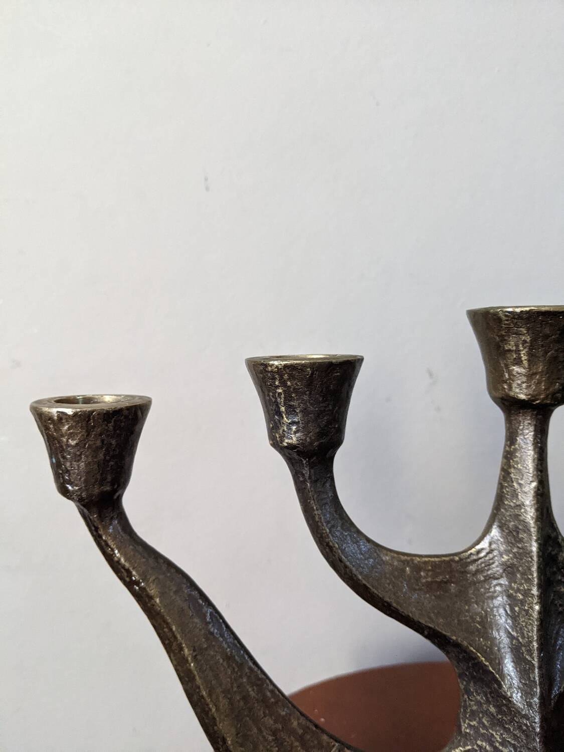 Vintage bronze candlestick chandelier in contemporary Scandinavian design.