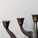 Vintage bronze candlestick chandelier in contemporary Scandinavian design.