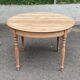 Table à manger ronde extensible Louis Philippe décapée en merisier massif 1
