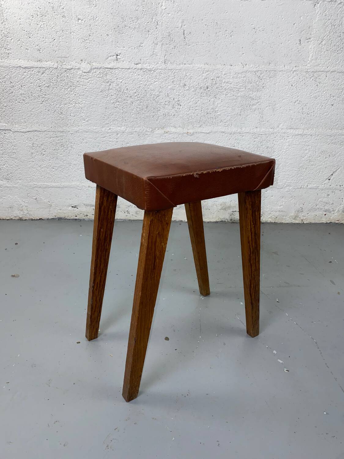 Small stool or footrest in wood and leather