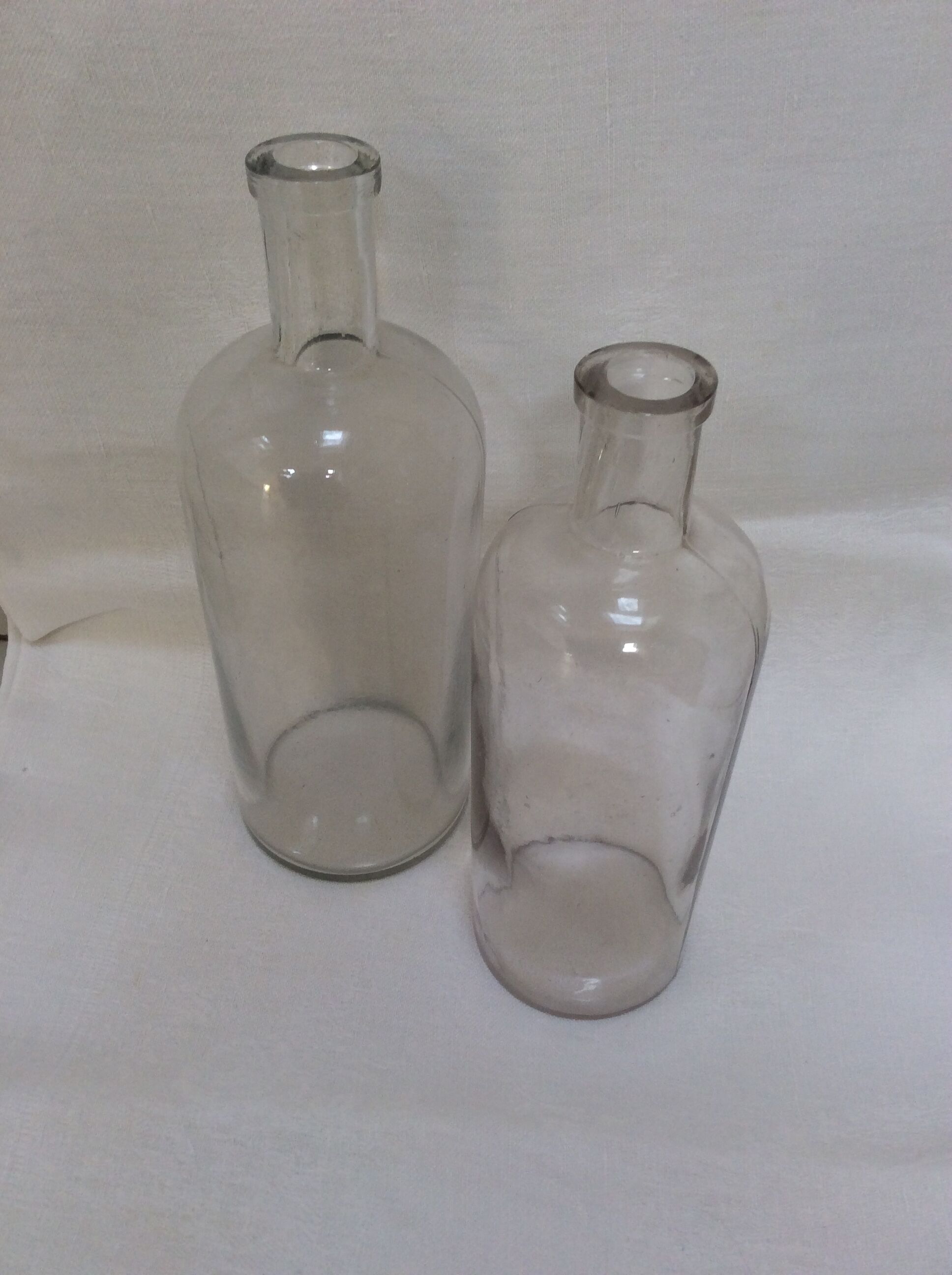 Pair of former pharmaceutical glass bottles