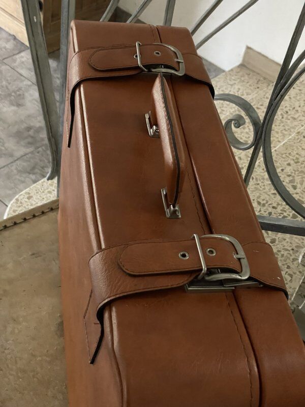 Antique suitcase with brown leather straps