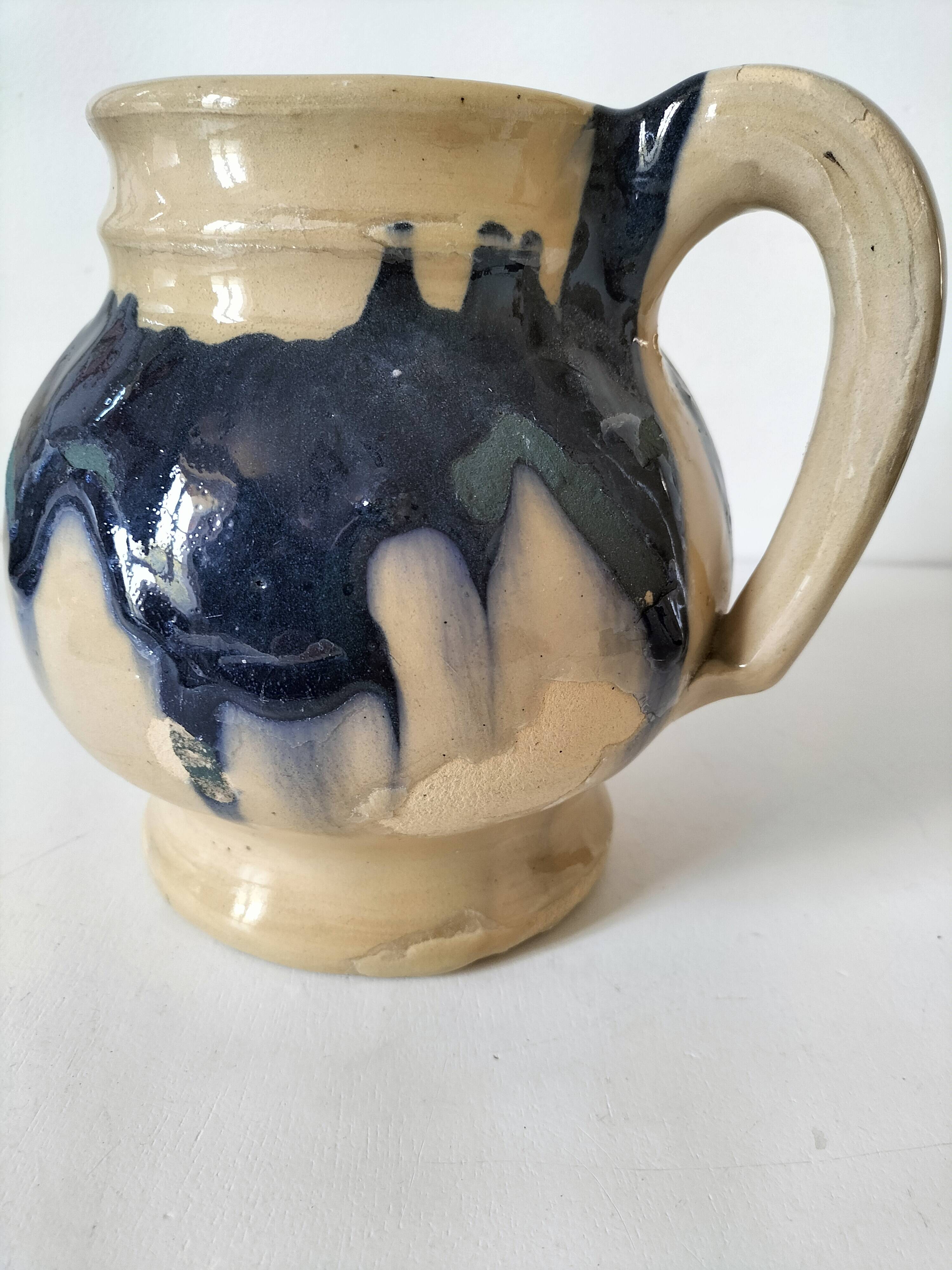 handcrafted ceramic jug with navy blue drip glaze.