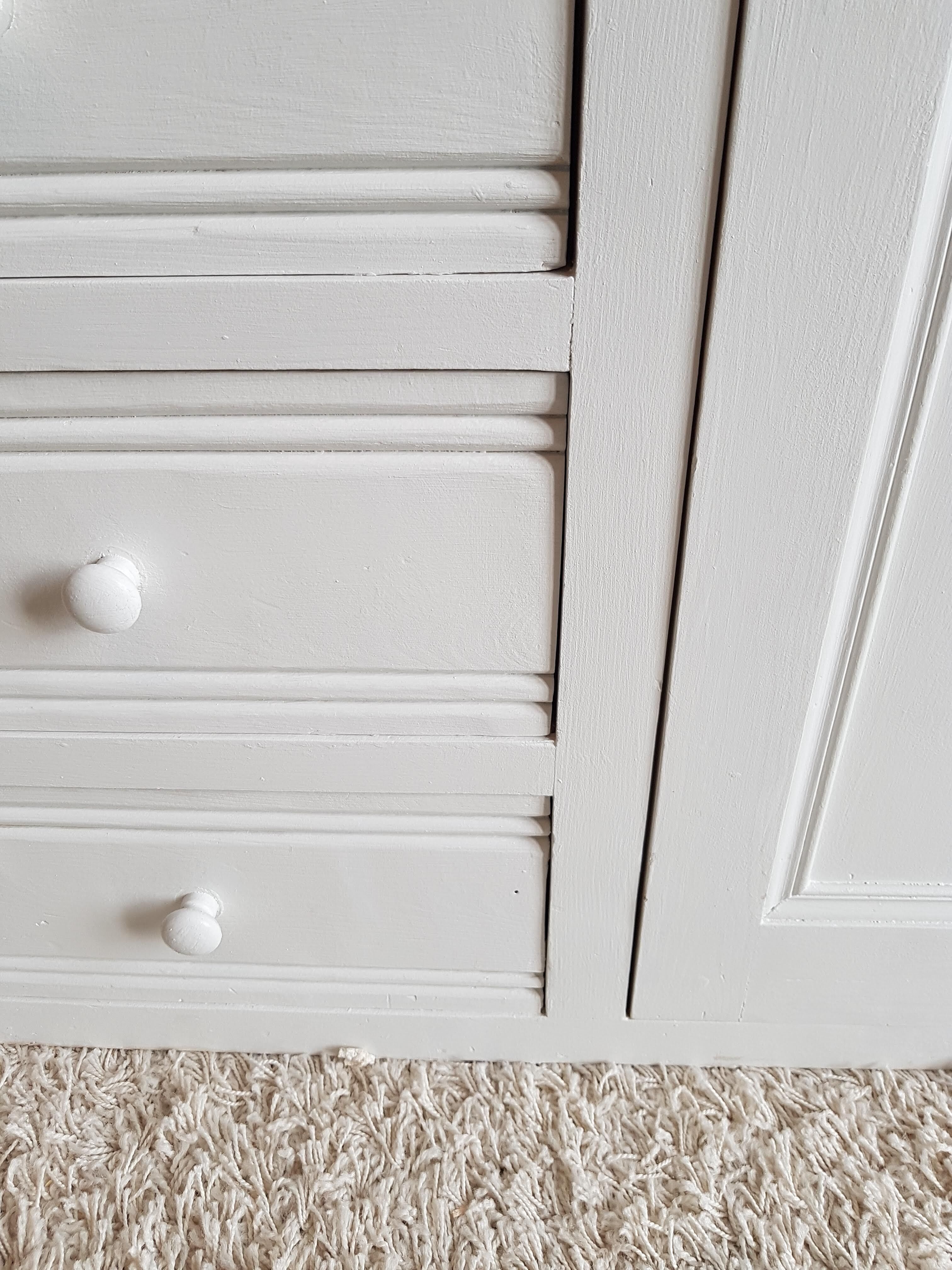 Old white asymmetrical chest of drawers