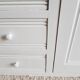 Old white asymmetrical chest of drawers