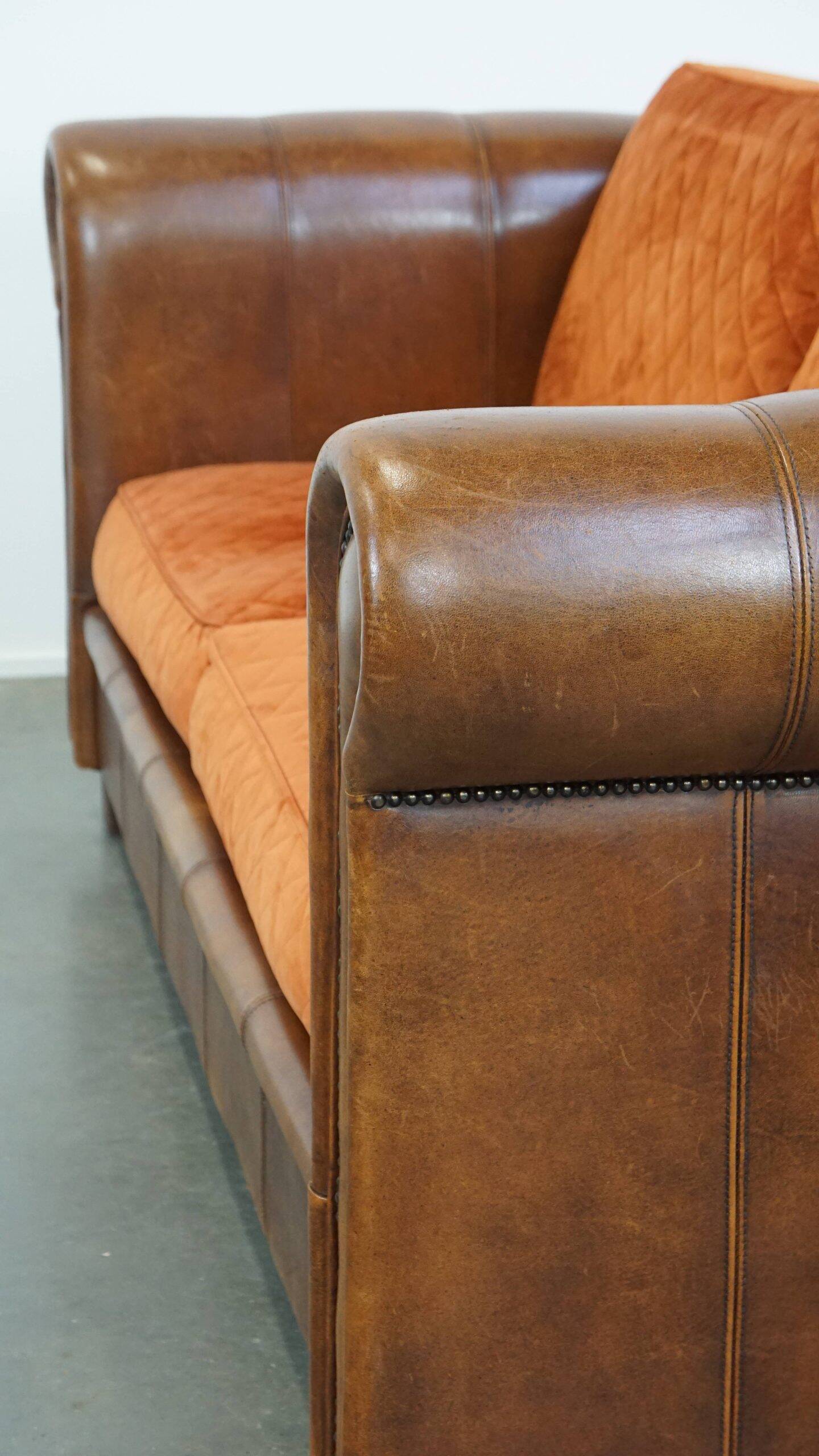 Luxury and comfortable sheepskin 2.5-seater sofa of top quality with orange fabric seat and back cushions