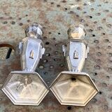 Pair of metal candlesticks, chiseled with a statuette in front, rose pattern in relief, art deco