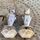 Pair of metal candlesticks, chiseled with a statuette in front, rose pattern in relief, art deco