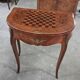 Half-moon gaming table in Louis XV style, made of precious wood marquetry.