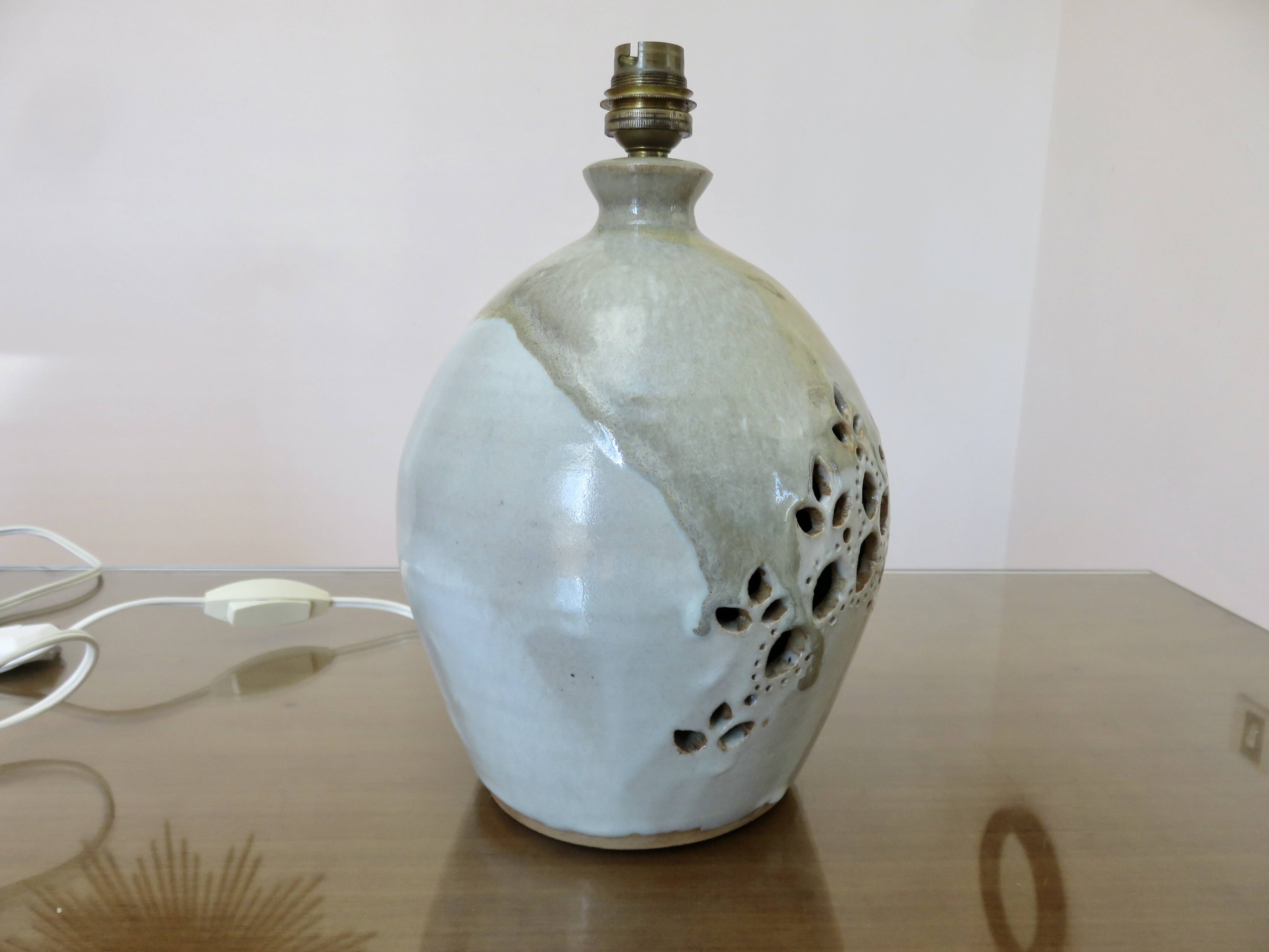 Ceramic lamp with double lighting and openwork design.