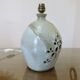 Ceramic lamp with double lighting and openwork design.