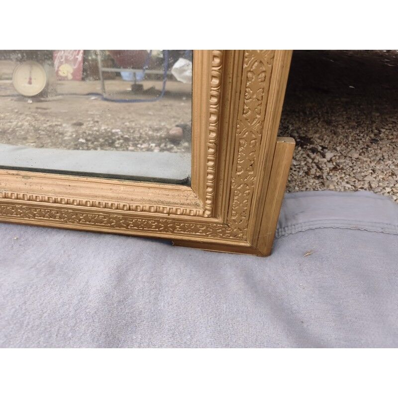 19th-century mirror in gilded wood and stucco.