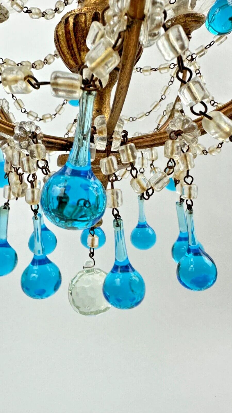Italian chandelier with blue beads and gilded wood.