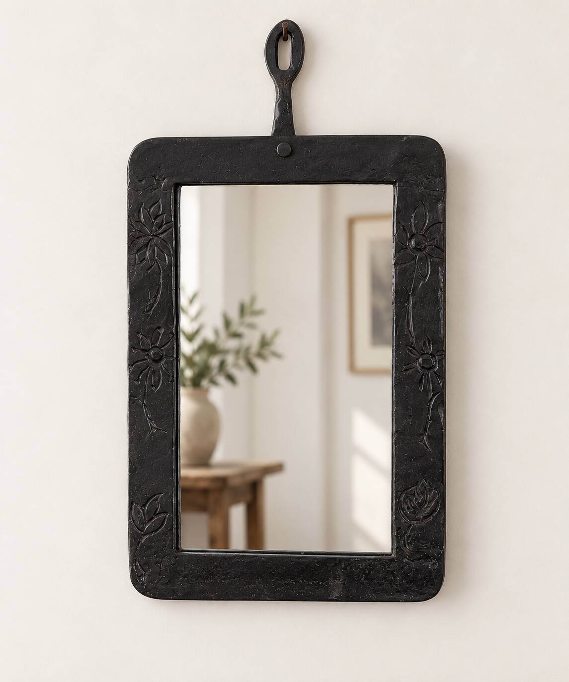 Vintage black wall mirror with floral decoration