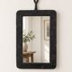 Vintage black wall mirror with floral decoration