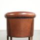 Vintage sheepskin club armchair finished with black piping